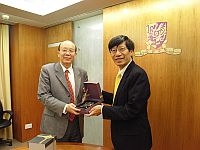 Prof. Lee Si-chen (left), President of Taiwan University receives a souvenir from Prof. Kenneth Young (right), Acting Vice-Chancellor of the Chinese University of Hong Kong
